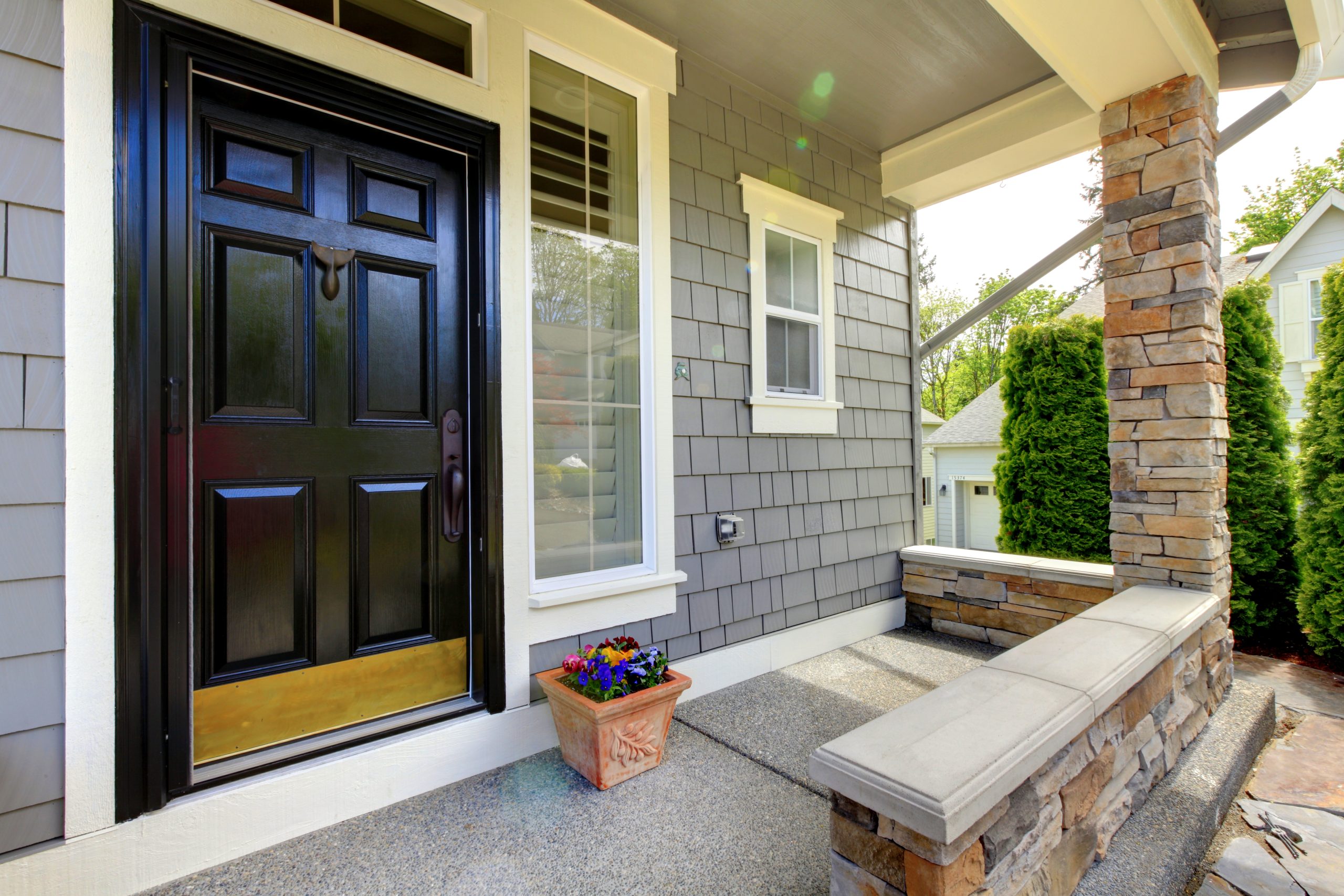 Grey house exterior with black door.