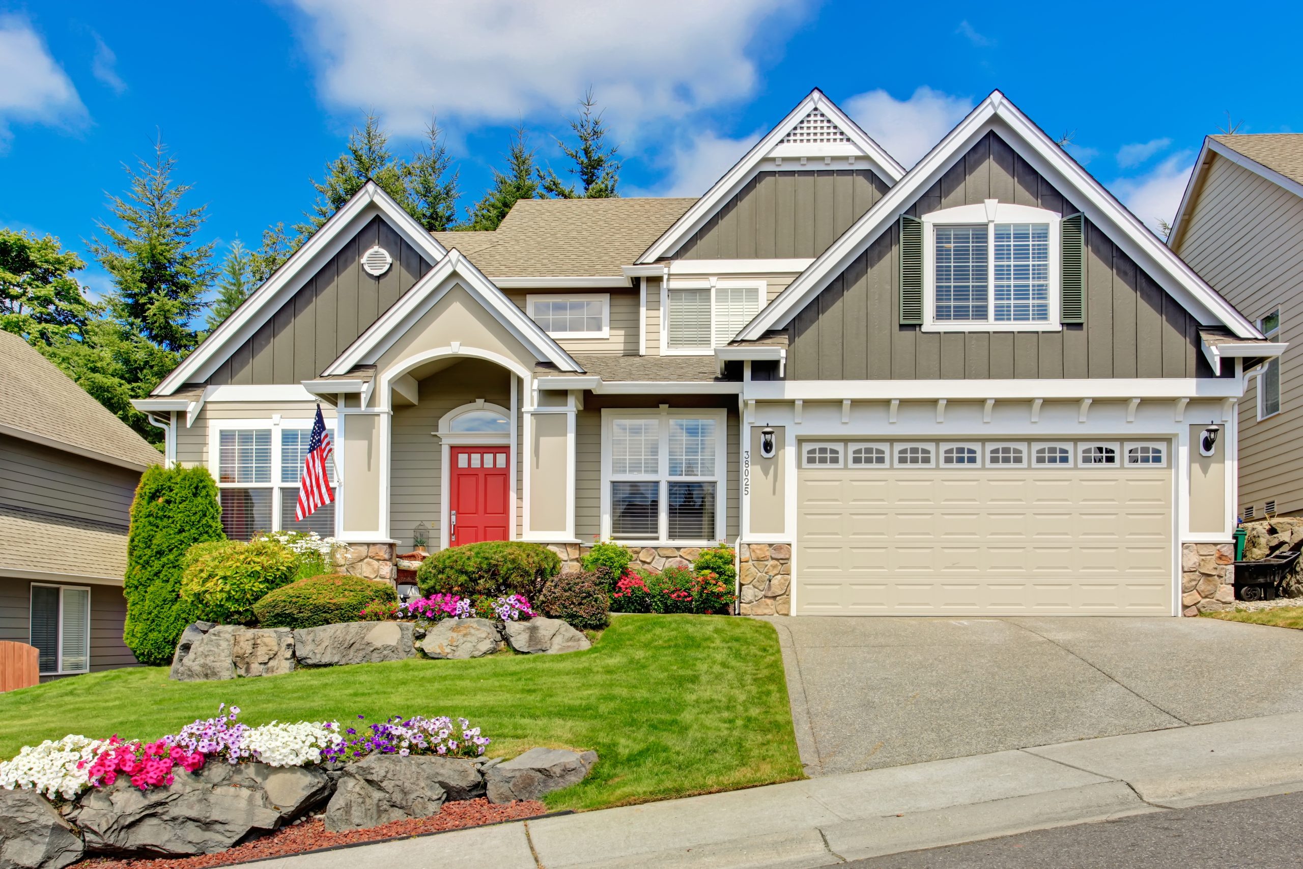 American house with beautiful landscape and vivid flowers